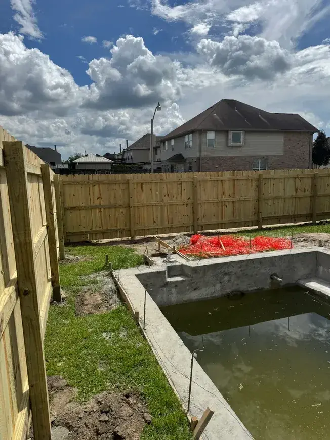 Fence framing new pool construction