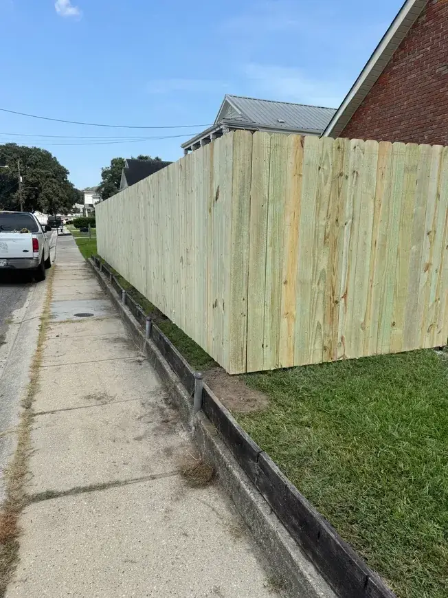 Long wood fence along sidewalk