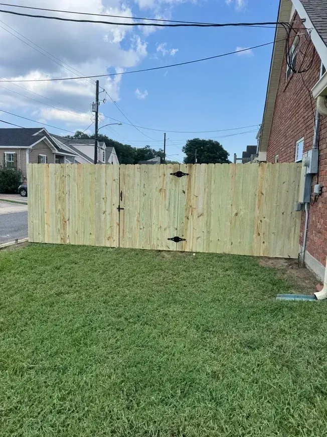 Wood gate beside brick house